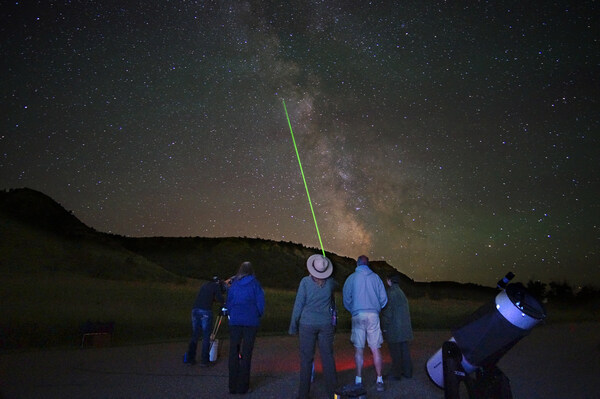 Explore the sparkling night sky at the Annual Dakota Nights Astronomy Festival at Theodore Roosevelt National Park in North Dakota. The festival returns August 30 through September 1 for a spectacular celebration under the stars. Credit: North Dakota Tourism/Jeff Zylland.