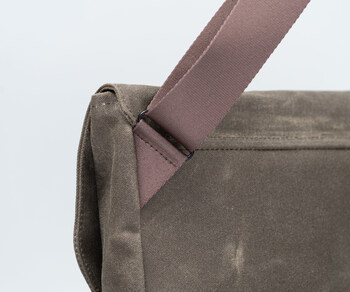 Angled shoulder strap keeps bag flush when worn crossbody