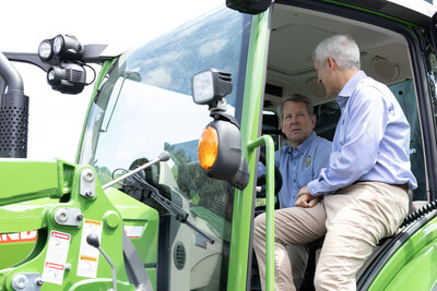 Georgia Governor Brian Kemp (left) sits in the driver's seat of a Fendt® Vario® Series tractor and discusses its innovative capabilities with AGCO Chairman, President & CEO Eric Hansotia (right) at the company's worldwide headquarters in Duluth, Georgia.