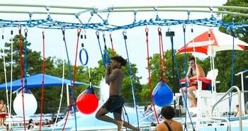 The AquaNinja FLX challenges kids, teens, and adults with adaptable obstacle elements as they traverse the pool