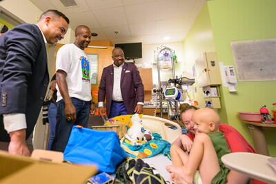 Pro and College Football Hall of Famer Champ Bailey, with Aflac U.S. President Virgil Miller (right) and Dr. Jason Payne (left) of the Aflac Cancer and Blood Disorders Center of Children's Healthcare of Atlanta deliver a My Special Aflac Duck to Brayden, a 5-year-old boy from Atlanta. Bailey, a former Georgia Bulldog star, visited the center today ahead of the Aflac Kickoff Game between Georgia Bulldogs and Clemson Tigers on Saturday in Atlanta on ABC.