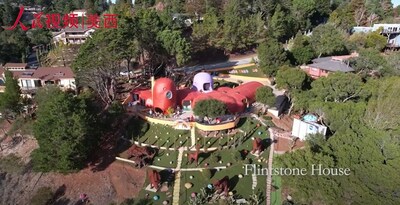 Driving along California's Highway 280, travelers are often struck by this unique house, surrounded by giant sculptures of dinosaurs and other creatures, standing out with its bold colors and fantastical design.