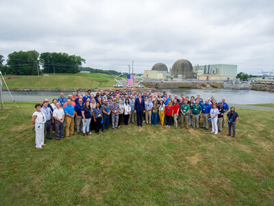 Gov. Glenn Youngkin, center, poses with a group of North Anna Power Station employees at an event there in July. (PRNewsfoto/Dominion Energy)