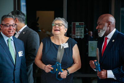 Attendees participate in a ribbon-cutting ceremony marking the grand reopening of 2100 Memorial Senior-Living Community on Aug. 29, 2024. From left to right: Eric Cobb, Houston Field Office Director for HUD; Connie Castillo, returning resident; and David A. Northern Sr., President and CEO of the Houston Housing Authority.