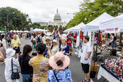 Visitors take photos in front of Guizhou's exhibition booth at the festival. [Photo provided to China Daily]