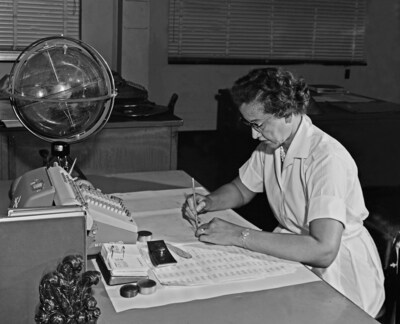 NASA research mathematician Katherine Johnson is photographed at her desk at NASA Langley Research Center with a globe, or "Celestial Training Device," in 1962. Image Credit: NASA / Langley Research Center