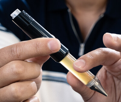 Cannabis patient twisting the XL Series Dablicator™ oil applicator for use.