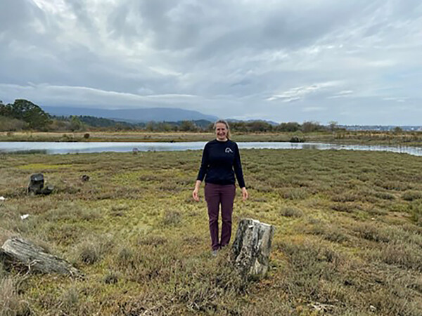 Sarah Nathan stands on a parcel of land in the Nanaimo Estuary which she helped restore from gravel to estuary habitat in 2018 on behalf of Ducks Unlimited Canada in partnership with the Nature Trust of B.C. and the Department of Fisheries and Oceans. Taken in 2023. (CNW Group/Ducks Unlimited Canada)