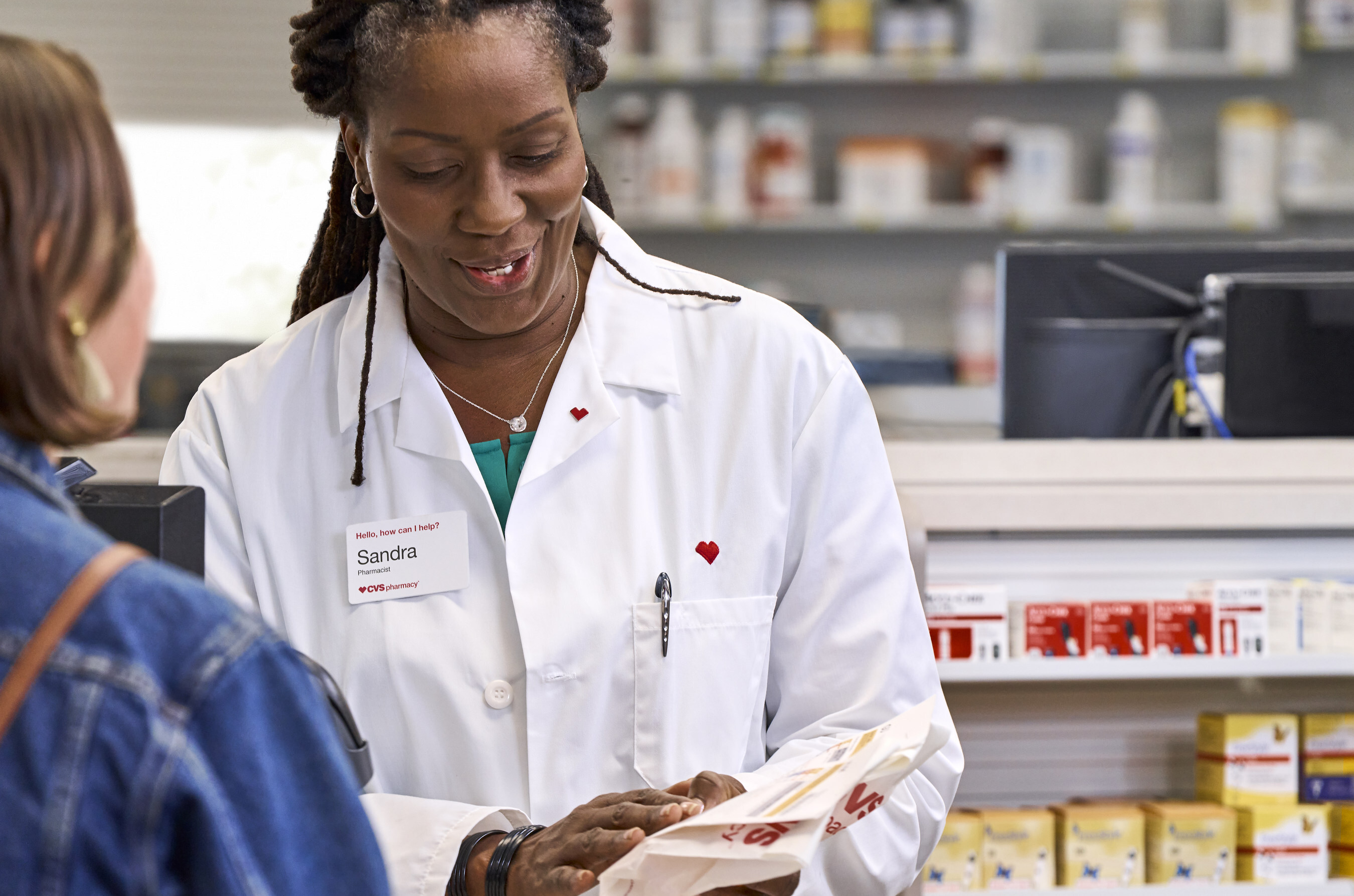 CVS pharmacist consults with patient about prescription