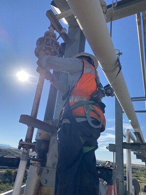 A Kinley technician adjusts pipe supports and inspects bolts after a valve upgrade.