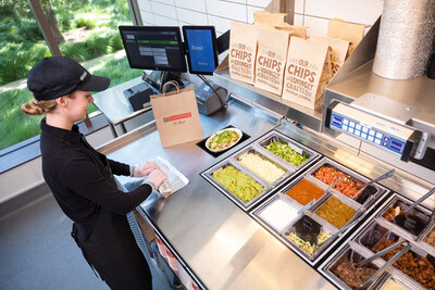 Chipotle's Augmented Makeline, created in collaboration with Hyphen, uses automated technology to build bowls and salads while Chipotle employees operate the top makeline to make burritos, tacos, quesadillas, and kid's meals. The Augmented Makeline is being tested at the company's Corona del Mar (CDM), Calif. location.