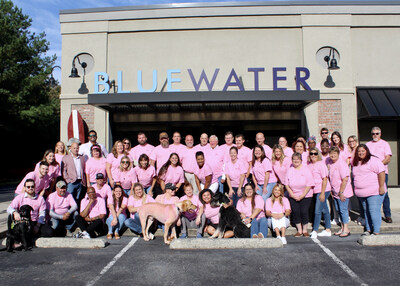 Employees at Blue Water headquarters supporting their Blue Turns Pink campaign with pink campaign shirts. (PRNewsfoto/Blue Water)