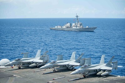 SOUTH CHINA SEA (June 7, 2024) The Arleigh Burke-class guided-missile destroyer USS Halsey (DDG 97) transits the South China Sea alongside the Nimitz-class aircraft carrier USS Theodore Roosevelt (CVN 71) in support of Valiant Shield 2024, June 7, 2024. Exercises such as Valiant Shield allows the Indo-Pacific Command Joint Forces the opportunity to integrate forces from all branches of services and with our allies to conduct precise, lethal, and overwhelming multi-axis, multi-domain effects that demonstrate the strength and versatility of the Joint Force and our commitment to a free and open Indo-Pacific. (U.S. Navy photo by Mass Communication Specialist Seaman Apprentice Aaron Haro Gonzalez)