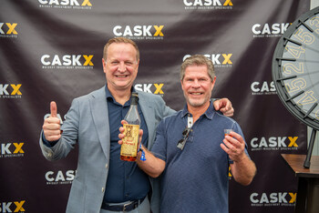 CaskX Managing Director Jon Reade poses with the winner of a Pappy Van Winkle 10 Year Old pour from the CaskX Bourbon Wheel. The Bourbon Wheel highlighted the potential of bourbon investment as an alternative asset.