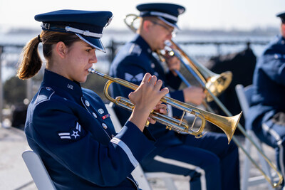 A trumpet player performs with the US Air Force Band of the Golden West's brass ensemble, Travis Brass, as part of a live outdoor ceremony.