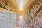 Restored corridor at Marquita Court featuring lively, period-inspired floor and wall tiles leading to residents' mailboxes, reflecting the building's 1920s heritage.