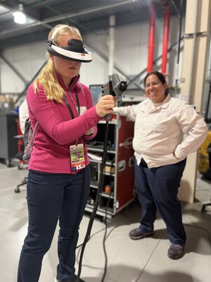 A student uses a virtual painter to experience the precision of painting a Honda vehicle.