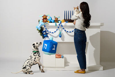 Pet parents can help their dogs get ready for Hanukkah with jelly donut and menorah rope toys. Giant statement pieces such as an oversized plush dreidel toy are trending this season.