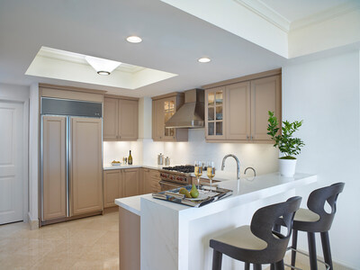 Sleek wood cabinetry is paired with durable yet luxurious Italian Lapitec stone countertops and a waterfall bar in the full gourmet kitchen.