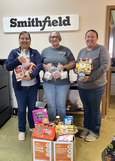 Left to right: Anel Coellar Sanchez, human resources generalist, Smithfield Foods; Renee Lynch, administrative assistant, Smithfield Foods; and Kara Thex, administrative assistant, Smithfield Foods, pack donated food items into boxes for the Laverne Food Pantry in Laverne, Oklahoma.