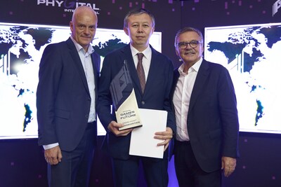 Nis Hatt, CEO of Phygital International (L) and Rene Fasel, Founder of Phygital International, (R) congratulate Yerbol Myrzabossynov (C) on Kazakhstan being selected as host country of the Games of the Future 2026