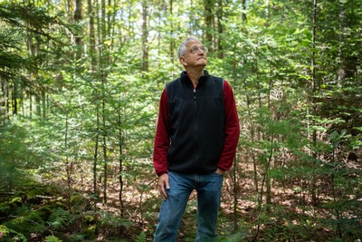 Tim Stout, a Family Forest Carbon Program enrolled landowner from Vermont, stands in the woods he stewards.