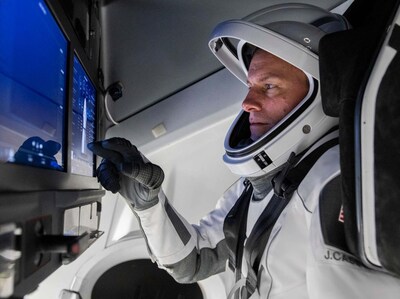 Astronaut Dr. Josh Cassada suited up in the SpaceX Dragon capsule operating the computerized piloting system.