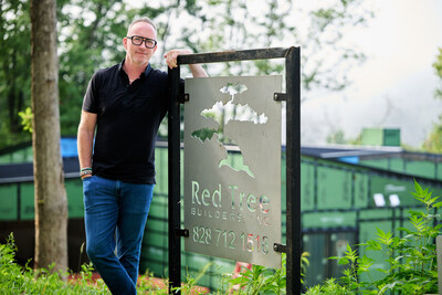 Brandon Bryant, owner of Red Tree Builders, at one of the company’s eco-conscious, custom homes in the scenic mountains, where luxury and sustainability come together in every project.