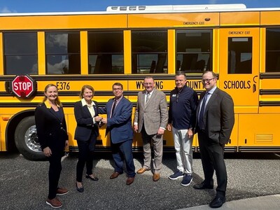 U.S. Senator Shelley Moore Capito presents the keys to a new GreenPower Type D all-electric BEAST school bus to Wyoming County (WV) School District Superintendent John Henry. They are joined by (L to R) BridgeValley Community & Technical College President Dr. Casey Sacks, GreenPower Vice President of Business Development & Strategy Mark Nestlen, GreenPower’s West Virginia School Bus Dealer Tim Matheny and ZETA Executive Director Albert Gore.