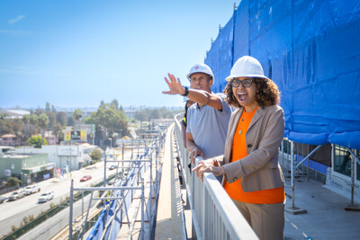 Martin Muoto (CEO of SoLa Impact) and Congresswoman Sydney Kamlager-Dove (CA-37) lake in the views of Crenshaw and Leimert Park from the rooftop deck of Crenshaw Lofts.