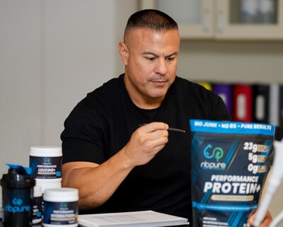 America's Strongest Firefighter Gene Tracy with Performance Protein+ in the NBPure lab in Phoenix, Arizona.