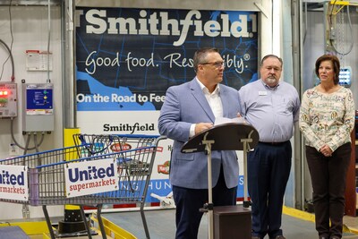 Brian Gordon, senior director of sales, Smithfield Foods; Scott Nettles, director of meat and seafood, United Supermarkets; and Dina Jeffries, CEO, South Plains Food Bank, announce the protein donation that will help take a bite out of hunger in West Texas.