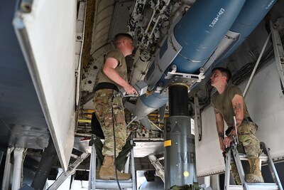 Members of the 28th Aircraft Maintenance Squadron weapons load crew insert an inert joint air-to-surface standoff missile into a B-1B Lancer. (U.S. Air Force photo by Staff Sgt. Jake Jacobsen).