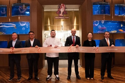 Members of Wynn management and representatives from Trip.com Group and SWH Import & Export Company Limited participate in a ribbon-cutting ceremony to officially open Drunken Fish. (PRNewsfoto/Wynn Resorts (Macau))