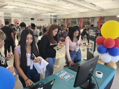 Students line up in the cafeteria to vote for their favorite menu items.