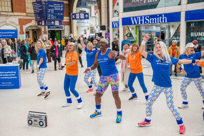 Mr. Motivator leads a Constant Contact flash mob at London Victoria Station.