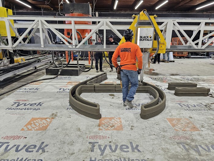 A member of the LiUNA team monitoring the print output of Black Buffalo 3D's NEXCON printer.