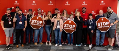 Atlantic Regional Director Jennifer Murray (centre) stands with many Unifor members and leaders holding "Stop scab labour!" signs at the 2024 Atlantic Regional Council. (CNW Group/Unifor)