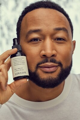 John Legend pictured with the Loved01 Face + Body Oil, now available on QVC.