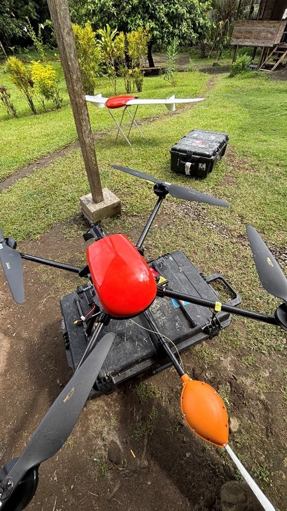 Geoscan’s 401 quadcopter drone with the Geoshark magnetometer, and fixed wing UAV (on stand) capturing high-resolution orthomosaic imagery and topography. (CNW Group/Adyton Resources Corporation)