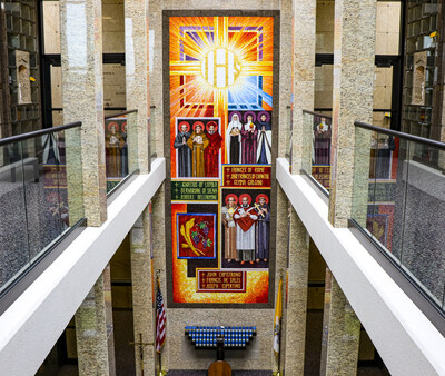 The Holy Name Chapel Mausoleum interior is adorned with colorful liturgical artwork, such as the Luminous mysteries and Corporal Works of Mercy. The chapel offers committal services, monthly Masses, spectacular courtyard atriums, and two-story balconies.