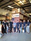 MasterPlan Construction Inc. team with Candice Cornish from Rebuilding Together Tampa Bay at their warehouse.