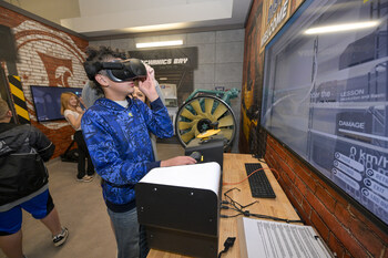 A student uses a VR headset during a job simulation activity for the transportation and supply chain sector. This activity is part of Career Commons, a 25,000-square-foot miniature city where students from 21 regional school systems can explore various professions through interactive, hands-on experiences. 


Photo Credit : Earl Neikirk/Neikirk Image