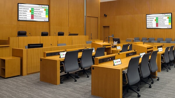 A mockup of the new software in action in a board room. The displays help board members and the public follow along with the school board meeting.