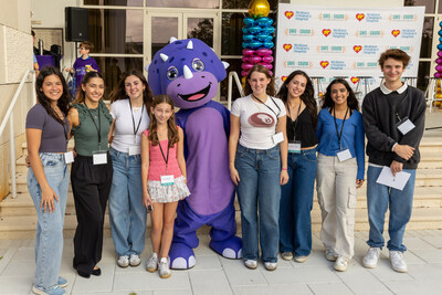 The Digital Safety Alliance Teen Advisory Board poses with iNvicta for Kids mascot Vic the Dino, at the Launch of the Digital Safety Certification Program in collaboration with iNvicta for Kids, Nicklaus Children’s Hospital and the Digital Safety Alliance at Rambam Day School at Temple Beth Am in Miami, FL.