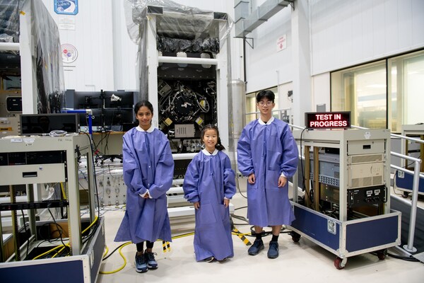 Twelve-year-old, Aadya Karthik of Seattle, Washington; nine-year-old, Rainie Lin of Lexington, Kentucky; and eighteen-year-old, Thomas Lui, winners of the 2023-2024 Power to Explore Student Writing Challenge observe testing at a NASA Glenn cleanroom during their prize trip to Cleveland. Credit: NASA