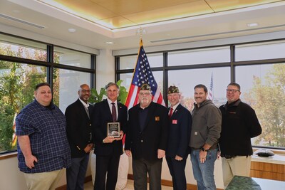 Keith Knopf, President & Chief Executive Officer for The Raley’s Companies (third from left) receives the Patriotic Citizen Award from the VFW organization at a ceremony on Nov. 7 at the company’s West Sacramento headquarters. Knopf is surrounded by current Raley’s team member and Commander of Oroville VFW, Robert Fager, (fourth from left) who nominated him for the honor.