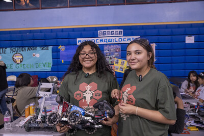 Two students are introduced to robotics, merging their cultural heritage with hands-on STEM learning experiences.