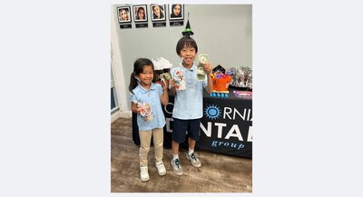 Two participants are thrilled after donating their candy to support the troops, receiving cash for each pound donated along with additional treats as a thank-you.