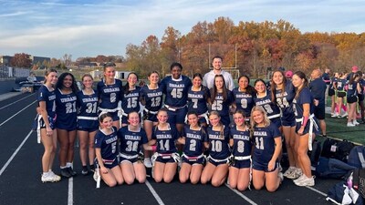 Jonathan Gessert, the CEO of 321 Web Marketing, with Urbana High School's all-girls flag football team